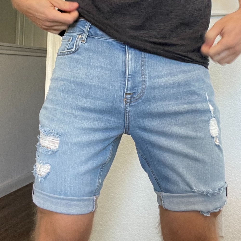 Mens Slim denim shorts in mid blue wash with rips